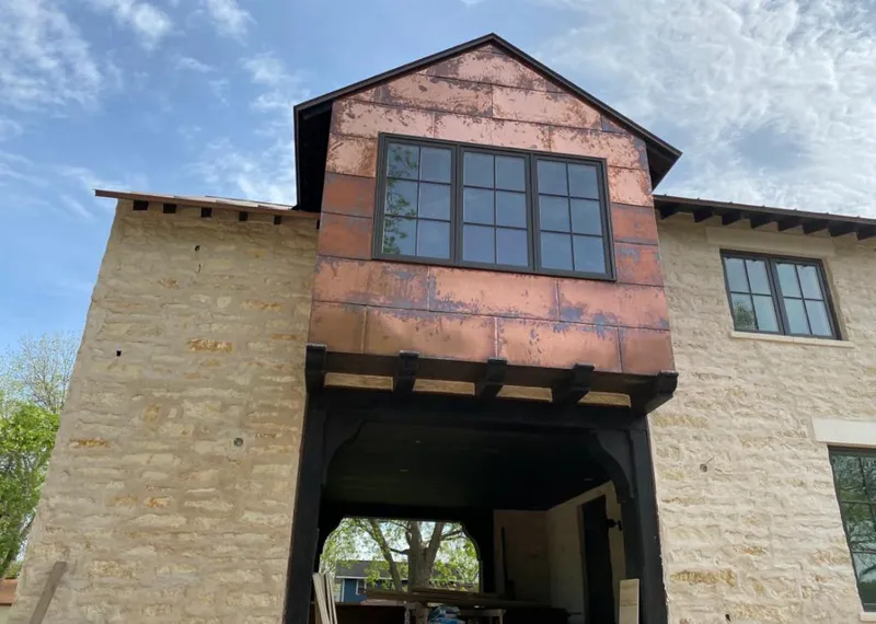 Copper metal panel facade on a stone building for Skylight Installation in Menomonee Falls